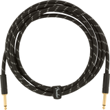 The image shows a Fender instrument cable with gold-plated 1/4" connectors on both ends and a black braided jacket. The durable woven design reduces tangling, and the cable features Fender branding. This professional-grade cable is designed for electric guitars, basses, and other instruments, ensuring reliable signal transmission and minimizing interference for stage or studio use.