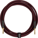 Coiled guitar cable with Fender logo on a white background