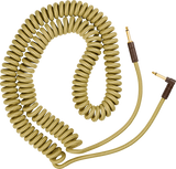 The image shows a coiled instrument cable with a golden braided exterior and textured pattern. It has standard 1/4" gold-plated plugs with dark connector housings. Designed to stretch and retract, it helps reduce clutter, extends reach, and lowers tripping risk. Popular among guitarists and musicians, it connects electric instruments to amps or interfaces while offering durability and a vintage-inspired look.