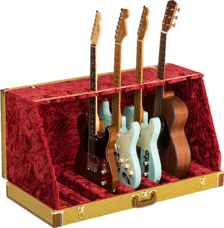 The image shows a professional guitar display case with a textured golden-yellow exterior and plush red velvet interior. It holds multiple guitars, including Fender-style electric guitars in black, cream, and blue, plus a natural wood acoustic guitar. The case features metal reinforcements, secure latches, and compartments for safe storage and display, ideal for musicians, collectors, or music stores.