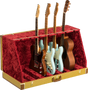 The image shows a professional guitar display case with a textured golden-yellow exterior and plush red velvet interior. It holds multiple guitars, including Fender-style electric guitars in black, cream, and blue, plus a natural wood acoustic guitar. The case features metal reinforcements, secure latches, and compartments for safe storage and display, ideal for musicians, collectors, or music stores.