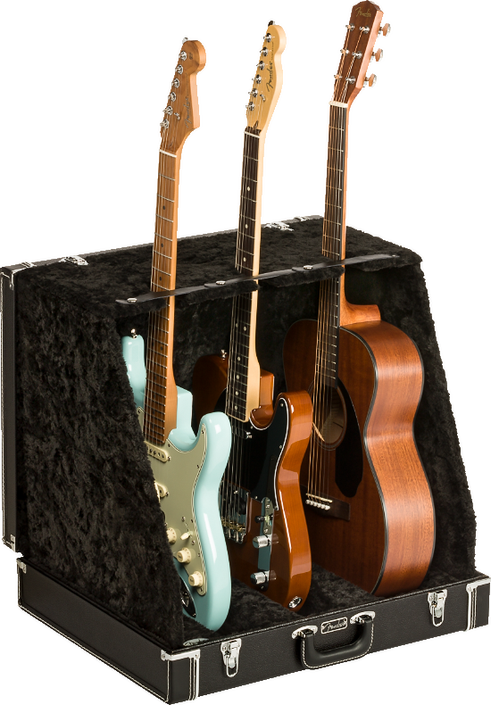 The image shows a professional black hard case/display stand with plush lining designed to hold and display multiple guitars. It securely supports three guitars: a light blue Stratocaster-style electric, a black electric, and a natural wood dreadnought acoustic. The sturdy case features metal latches and neck supports, ideal for musicians, collectors, stores, or studios needing safe, accessible multi-guitar storage.