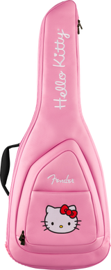 The image shows a bright pink Fender guitar gig bag with a Hello Kitty theme. It features white "Hello Kitty" text printed vertically, the Hello Kitty character with a red bow on the front pocket, padded construction, backpack-style straps, a front accessory pocket, and zipper closures. This official collaboration blends Fender guitar protection with Sanrio’s iconic character design.