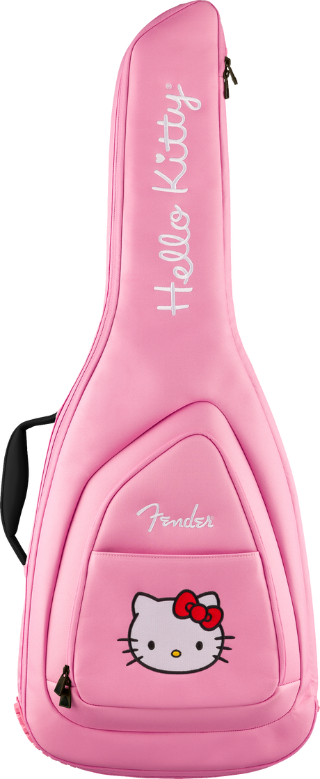 The image shows a bright pink Fender guitar gig bag with a Hello Kitty theme. It features white "Hello Kitty" text printed vertically, the Hello Kitty character with a red bow on the front pocket, padded construction, backpack-style straps, a front accessory pocket, and zipper closures. This official collaboration blends Fender guitar protection with Sanrio’s iconic character design.