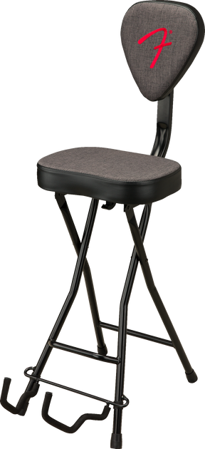 The image shows a foldable, height-adjustable musician’s stool with a padded gray seat and backrest featuring a red Fender logo. It has a black metal X-style frame and a built-in guitar stand at the base for resting instruments. Designed for guitarists and other musicians, this ergonomic stool combines comfort and practicality in an official Fender-branded accessory.