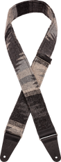 The image shows a guitar strap with a grayscale woven pattern in shades of gray and black. It has dark leather or synthetic leather end tabs with adjustment holes for attaching to a guitar. This strap combines functionality and style, allowing musicians to play standing while supporting the instrument’s weight. Its modern design and adjustable length offer comfort and a sophisticated look that suits various guitars and playing styles.