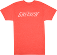 The image shows a coral/orange-red t-shirt with "GRETSCH" printed in white across the chest. This shirt is branded merchandise from Gretsch, a renowned musical instrument company known for guitars, drums, and other instruments since 1883. Gretsch is especially famous for its hollow-body electric guitars favored by many iconic musicians.