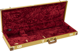 The image shows a hard shell guitar case with a tan tweed exterior, gold metal hardware, and a brown leather handle. It has a deep red plush velvet interior with custom-molded foam compartments to securely hold an electric guitar. The case features multiple latches for secure closure, providing sturdy protection and safe transport for musicians.