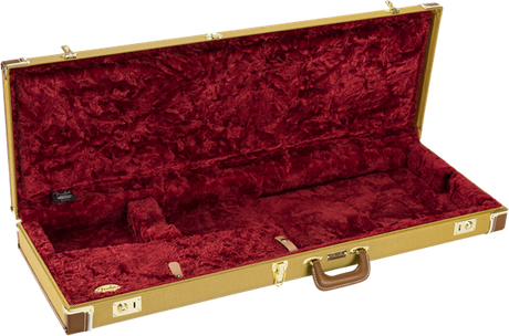 The image shows a hard shell guitar case with a tan tweed exterior, gold metal hardware, and a brown leather handle. It has a deep red plush velvet interior with custom-molded foam compartments to securely hold an electric guitar. The case features multiple latches for secure closure, providing sturdy protection and safe transport for musicians.