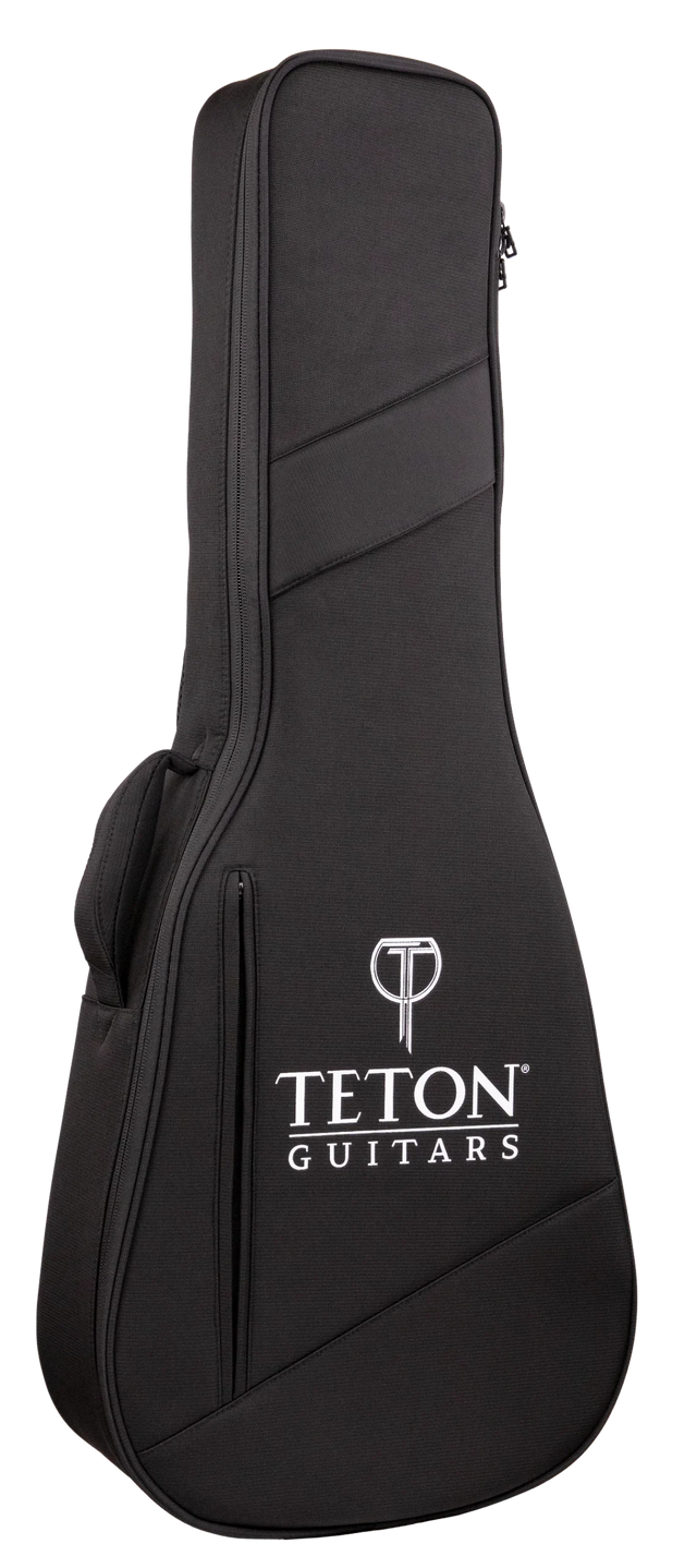 The image shows a black Teton Guitars soft gig bag made of durable fabric with padded protection. It features the white Teton logo and "T" symbol on the front, diagonal seam design, dual zippers, a top carrying handle, and a shoulder strap attachment. This lightweight, portable case is ideal for safely transporting acoustic guitars or similar-sized string instruments.