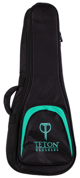 The image shows a Teton TBT12TL Tenor Ukulele Gig Bag, designed to protect and carry a tenor-sized ukulele. The bag features a black exterior with a front zippered pocket and padded shoulder straps for easy transport. It showcases the Teton logo and appears sturdy and well-padded, ideal for musicians seeking durable ukulele protection.