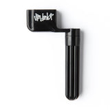 A black guitar string winder on a white background