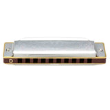 The image shows a 10-hole diatonic harmonica with a chrome top plate engraved with "GOLDEN," dark reddish-brown comb, and metal cover plates. The key of D is marked on the left side, and the harmonica features golden trim. This classic design is commonly used in blues, folk, country, and rock music.
