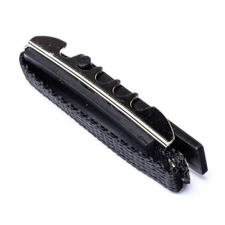A black toggle guitar capo on a white background