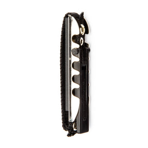 A black toggle guitar capo on a white background