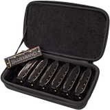 The image shows a harmonica set in a black padded carrying case with multiple harmonicas arranged inside. One harmonica is labeled "BLUESBAND," indicating a blues set. The case holds harmonicas in various keys, commonly used by blues and folk musicians for different tunings. The protective foam compartments keep the instruments secure and organized for easy transport and access.