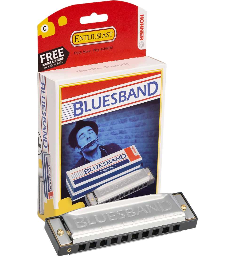 The image shows a Hohner Blues Band 10-hole diatonic harmonica in the key of C with a silver body and plastic comb, alongside its red and white Hohner Enthusiast packaging. The packaging features a player image, a "FREE ONLINE LESSONS" promotion, and the slogan "Enjoy Music - Play HOHNER!" This reliable, entry-level harmonica is popular for blues, folk, and rock music.