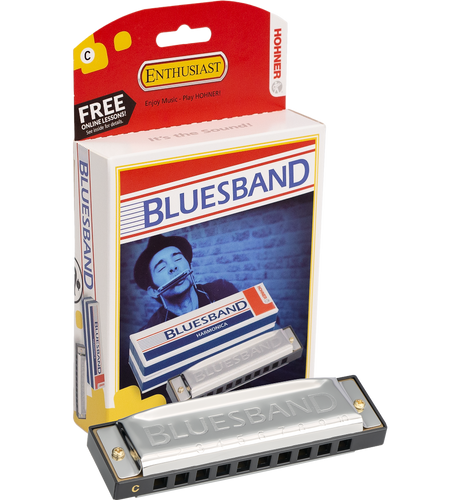 The image shows a Hohner Blues Band 10-hole diatonic harmonica in the key of C with a silver body and plastic comb, alongside its red and white Hohner Enthusiast packaging. The packaging features a player image, a "FREE ONLINE LESSONS" promotion, and the slogan "Enjoy Music - Play HOHNER!" This reliable, entry-level harmonica is popular for blues, folk, and rock music.