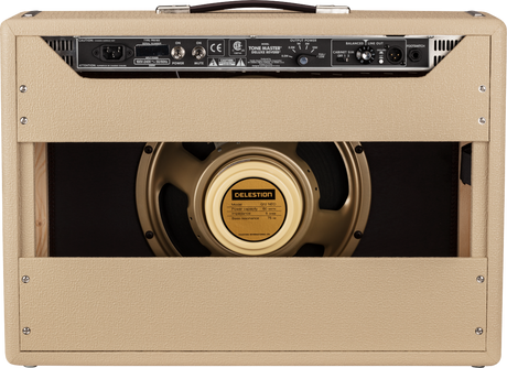 The image shows the back of a Fender Tone Master Deluxe Reverb guitar amplifier with blonde tolex, a leather handle, and a rear control panel featuring power, mute, and output switches. A 12-inch Celestion G12 NEO speaker with a gold cone is visible through the cabinet opening. The amp has traditional corner hardware, ventilation grilles, and a professional build, blending vintage Fender style with modern digital modeling technology.