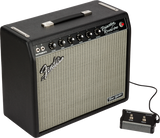The image shows a Fender Princeton Reverb guitar amplifier with a black tolex exterior and silver-gray grille cloth. It features the Fender logo, "Princeton Reverb Amp" labeling, a control panel with multiple knobs, two instrument input jacks, a connected footswitch, a top carrying handle, and a "Tone Master" badge indicating it’s a modern digital model replicating the classic tube amp sound.