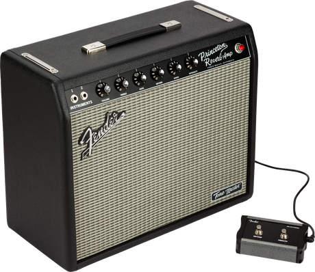 The image shows a Fender Princeton Reverb guitar amplifier with a black tolex exterior and silver-gray grille cloth. It features the Fender logo, "Princeton Reverb Amp" labeling, a control panel with multiple knobs, two instrument input jacks, a connected footswitch, a top carrying handle, and a "Tone Master" badge indicating it’s a modern digital model replicating the classic tube amp sound.