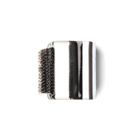 A short steel guitar slide with Velcro on a white background