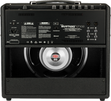 The image shows the back panel of a Fender Mustang GTX50 guitar amplifier. It features a Celestion speaker visible through the open back, multiple I/O options including XLR outputs, FX loop, USB, footswitch, and Bluetooth connectivity. The amp is covered in black tolex with a sturdy handle and supports 100V-240V AC power. This 50-watt digital modeling amp offers versatile tones and modern features for practice and performance.