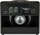 The image shows the rear view of a Fender Mustang GTX100 guitar amplifier. It features an open-back design with a visible 12-inch Celestion speaker, labeled "MUSTANG GTX100." Connectivity includes XLR outputs, line out, FX send/return, footswitch jack, USB, Bluetooth, AC power input, and an on/off switch. The amp has black tolex, metal corner protectors, and a handle. It is a 100-watt digital modeling amp from Fender’s Mustang series.