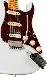 The image shows a Fender Stratocaster electric guitar with a white body, burgundy tortoiseshell pickguard, maple neck, and three single-coil pickups (two cream, one black). It features a chrome tremolo bridge, three control knobs, and standard Stratocaster electronics. Attached is a black Fender wireless transmitter, enabling cable-free play, blending classic design with modern wireless functionality for live performance.