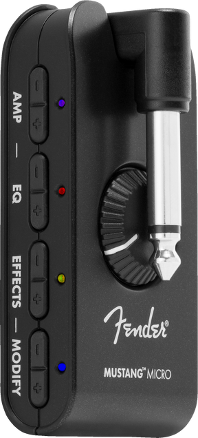The image shows a Fender Mustang Micro, a compact black headphone guitar amplifier with control knobs labeled AMP, EQ, EFFECTS, and MODIFY, each with colored LED indicators. It features a guitar input jack on the right, a headphone output port, and the Fender logo. This portable device plugs directly into an electric guitar for silent practice with amp simulation and effects, ideal for quiet, on-the-go playing.