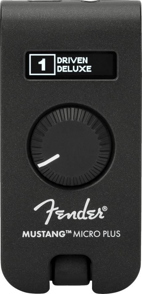 The image shows a Fender Mustang Micro Plus, a compact black guitar headphone amplifier with a textured finish. It features a digital display reading "1 DRIVEN DELUXE," a large rotary knob, the Fender logo, and the model name. The device plugs directly into an electric guitar for silent practice, offering amp simulations and effects in a portable design.