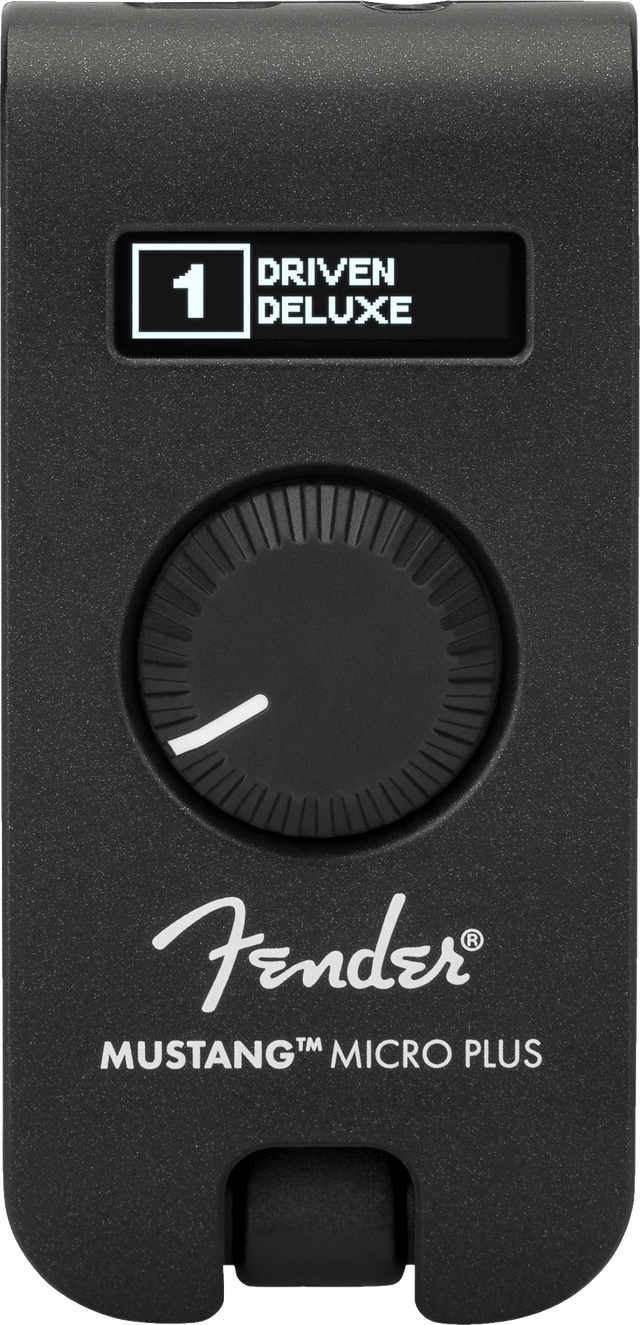 The image shows a Fender Mustang Micro Plus, a compact black guitar headphone amplifier with a textured finish. It features a digital display reading "1 DRIVEN DELUXE," a large rotary knob, the Fender logo, and the model name. The device plugs directly into an electric guitar for silent practice, offering amp simulations and effects in a portable design.