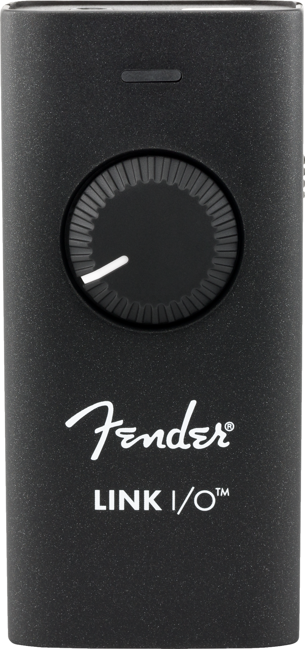 The image shows a Fender Link I/O, a compact black audio interface with a speckled finish, featuring a large central rotary knob, a small top button, Fender branding, and a USB port. It connects guitars and electric instruments to computers or mobile devices for recording, practicing, and live use, enabling digital audio input for musicians and producers.