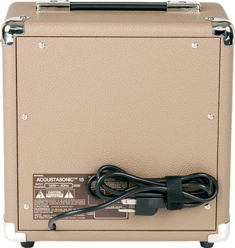 The image shows the back panel of an Acoustasonic 15 acoustic guitar amplifier. It features a tan/beige textured exterior, chrome corner protectors, and a carrying handle. The panel includes power and input/output connections. Compact and portable, this amp is designed to provide clean, natural amplification for acoustic guitars, making it ideal for practice, small gigs, or recording.