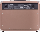 The image shows the back panel of a brown/tan Fender Acoustasonic 40 guitar amplifier with metal corner protectors and a black handle. Visible details include the model name, power specs (120V~60Hz, 130W), XLR and other audio ports, safety labels, Fender manufacturing info, balanced line out, and ventilation. This 40-watt amp is designed for acoustic guitars, ideal for practice and small to medium venues.