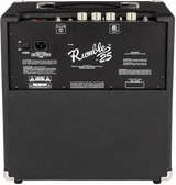 The image shows a Fender Rumble 25 bass combo amplifier with a compact black cabinet and classic Fender design. It features "Rumble 25" branding, top panel control knobs, metal corner protectors, and rear input/output connections. This 25-watt amp is ideal for bass guitar practice and small venues, known for being affordable and reliable for beginners and experienced players.