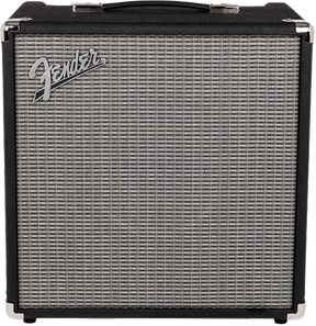 The image shows a Fender compact bass combo amplifier with a black tolex exterior, metal corner protectors, and a black handle. The silver-gray grille cloth features the Fender logo in the upper left corner. This portable amp is commonly used by bassists for practice, small gigs, or recording, offering quality bass amplification in a compact design.
