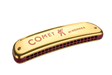 The image shows a Hohner "Comet" diatonic harmonica with a gold metal cover plate featuring red "COMET" text and the Hohner logo. It has a red/burgundy comb visible at the bottom where the reed chambers are located. Hohner is a renowned German maker of harmonicas and musical instruments for over 160 years.