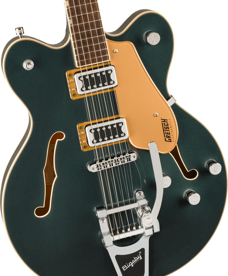 The image shows a beautiful Gretsch hollow-body electric guitar with a deep green finish and cream binding. It features f-holes, an orange pickguard with the "GRETSCH" logo, two gold-ringed humbucking pickups, a Bigsby vibrato tailpiece, four control knobs, a rosewood fingerboard with dot inlays, and chrome hardware. This high-end model blends classic Gretsch style with versatile tones ideal for rockabilly, jazz, and indie rock.