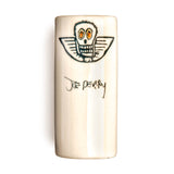 White ceramic guitar slide with a skull design and 'Joe Perry' signature on a white background