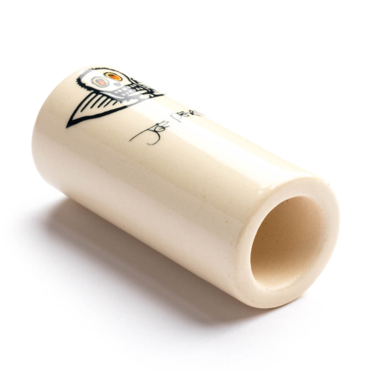 A white ceramic guitar slide with skull design on a white background