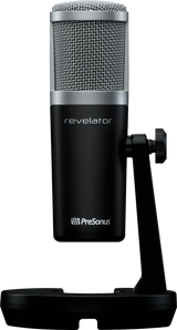 The image shows a PreSonus Revelator USB condenser microphone with a large silver mesh grille and black body featuring the "revelator" branding and PreSonus logo. It has a built-in desktop stand and professional studio-grade design, commonly used for music production, podcasting, streaming, and home studios to capture high-quality audio.
