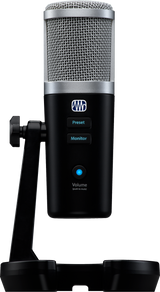 The image shows a professional USB large-diaphragm condenser microphone with a silver mesh grille and black body on a desktop stand. It features preset and monitor buttons, a volume knob with blue LED and push-to-mute function. Branded with a logo resembling "PreSonus," it’s ideal for home studio recording, podcasting, voice-over, and instrument capture, favored for its studio quality and easy plug-and-play USB connectivity.