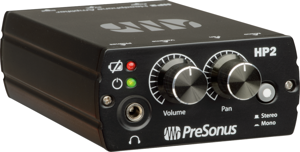 The image shows a PreSonus HP2 headphone amplifier, a compact black unit used in studios for headphone distribution. Visible features include a headphone jack, volume and pan knobs, stereo/mono switch, power and mute buttons, and red/green LED indicators. It allows multiple users to monitor audio with individual volume and stereo control by connecting to mixers or audio interfaces.