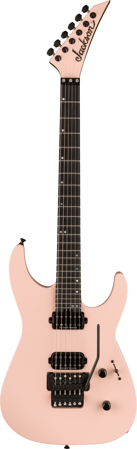 The image shows a Jackson electric guitar with a modern, angular body and pointed headstock in light pink/salmon. It features black tuning pegs, two black humbucker pickups, a black tremolo bridge, and a dark wood fretboard with white dot markers. The body has at least two control knobs, and the guitar has six strings. This distinctive design is popular among rock and metal players.