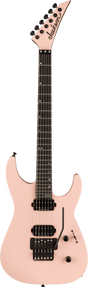 The image shows a Jackson electric guitar with a modern, angular body and pointed headstock in light pink/salmon. It features black tuning pegs, two black humbucker pickups, a black tremolo bridge, and a dark wood fretboard with white dot markers. The body has at least two control knobs, and the guitar has six strings. This distinctive design is popular among rock and metal players.