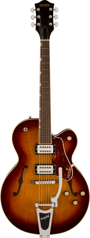 The image shows a Gretsch hollow body electric guitar with a sunburst finish and f-holes. It features two Filter'Tron style humbucking pickups, a Bigsby vibrato tailpiece, chrome hardware, and multiple control knobs. The dark headstock displays a gold "GRETSCH" logo with six chrome tuners. Additional details include a bound rosewood fretboard, tortoiseshell pickguard, and white body binding, showcasing Gretsch’s classic vintage design.