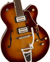 The image shows a beautiful Gretsch hollow-body electric guitar with a sunburst finish, prominent f-holes, and two chrome humbucker pickups. It features a Bigsby vibrato tailpiece, tortoiseshell pickguard with the Gretsch logo, traditional archtop bridge, multiple control knobs, and a rosewood fretboard with block inlays. This professional-quality instrument is known for its warm tone, favored in jazz, rockabilly, and rock genres.