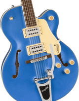 The image shows a beautiful blue hollow-body Gretsch electric guitar with a classic single-cutaway archtop design and f-holes. It features cream binding, two humbucking pickups with cream rings, chrome hardware, a Bigsby vibrato tailpiece, multiple control knobs, and an adjustable bridge. The dark rosewood fretboard has pearl block inlays. This iconic guitar is favored in jazz, rockabilly, and rock genres for its bright, articulate tone.