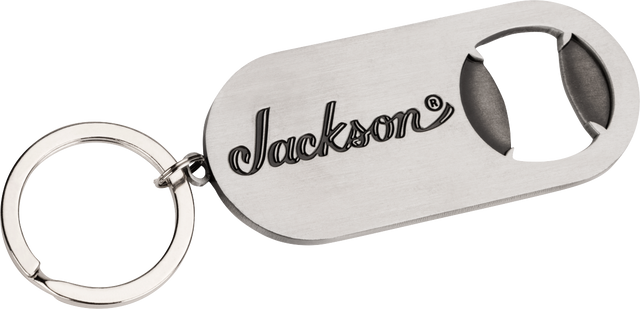 The image shows a metal keychain bottle opener branded with the Jackson logo, a well-known electric guitar manufacturer popular in rock and metal music. This promotional merchandise item highlights Jackson’s identity within the guitar industry, where they produce accessories alongside their high-performance guitars like the Soloist, Dinky, and Rhoads models.